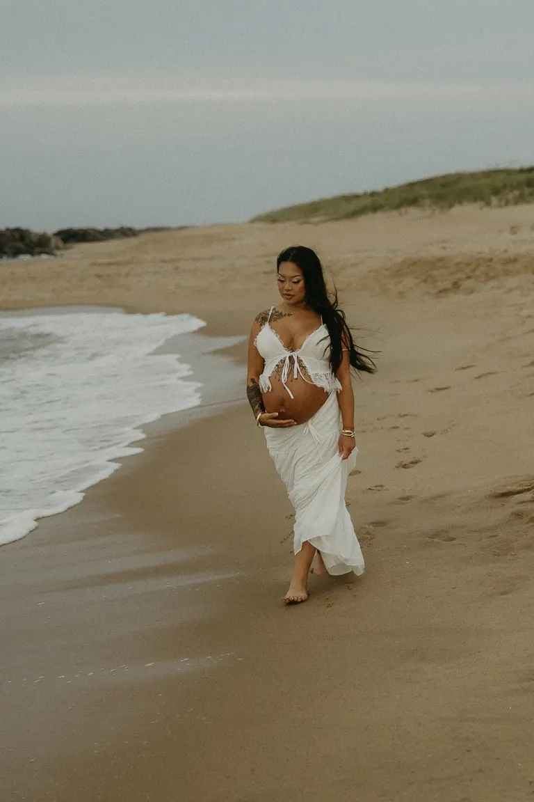 couples maternity photoshoot on fort story beach in Virginia Beach, Virginia