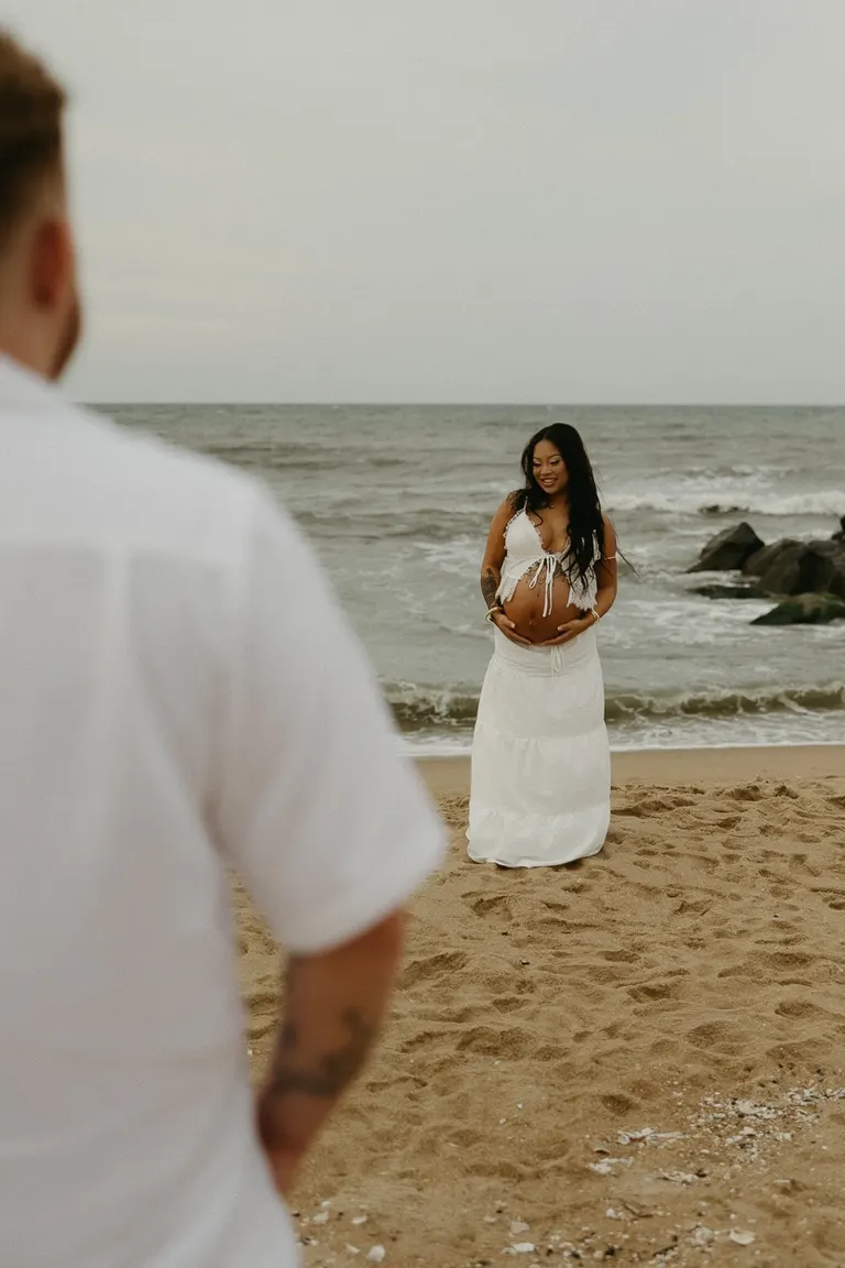 couples maternity photoshoot on fort story beach in Virginia Beach, Virginia